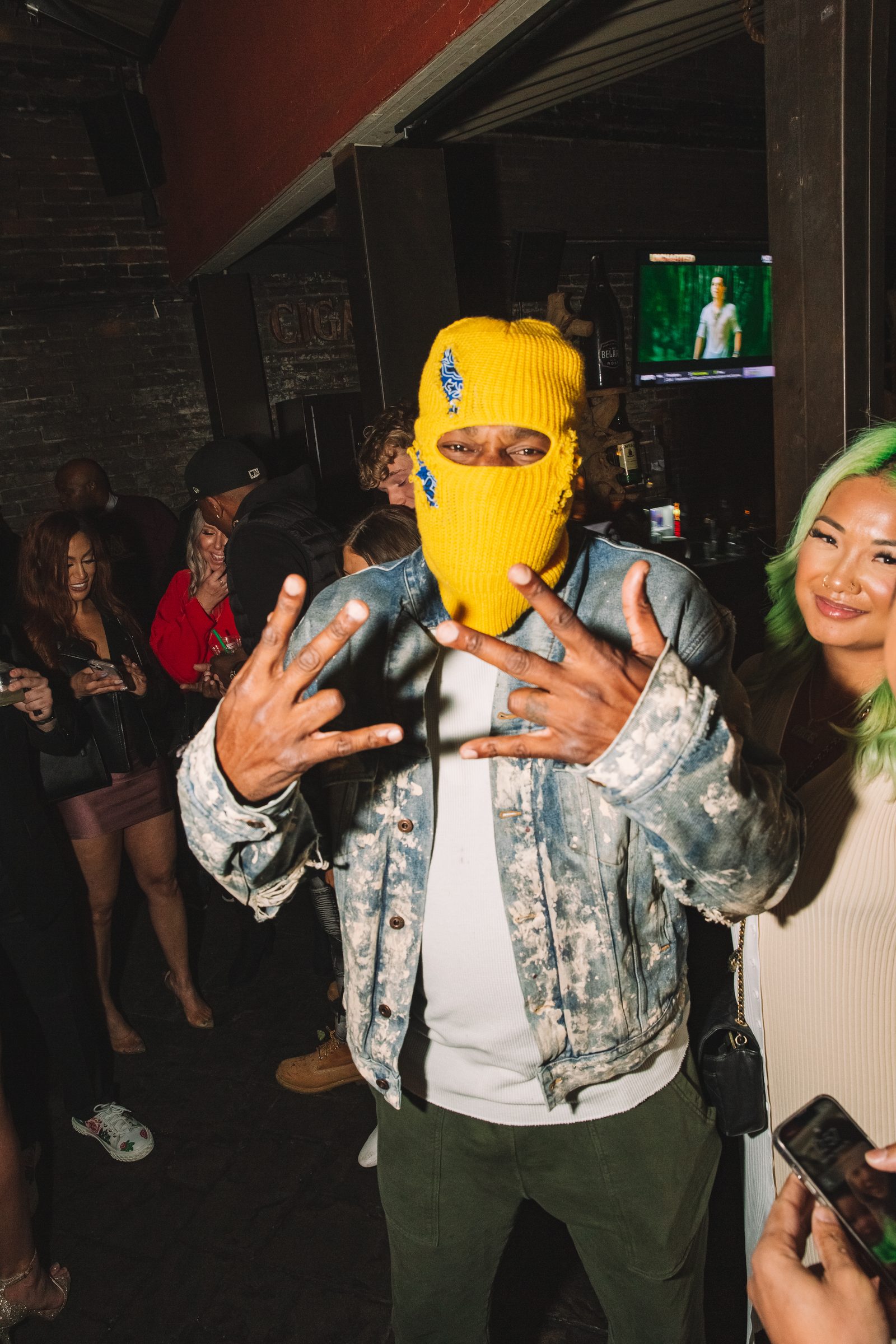 Guest in a yellow mask photographed in the activation room