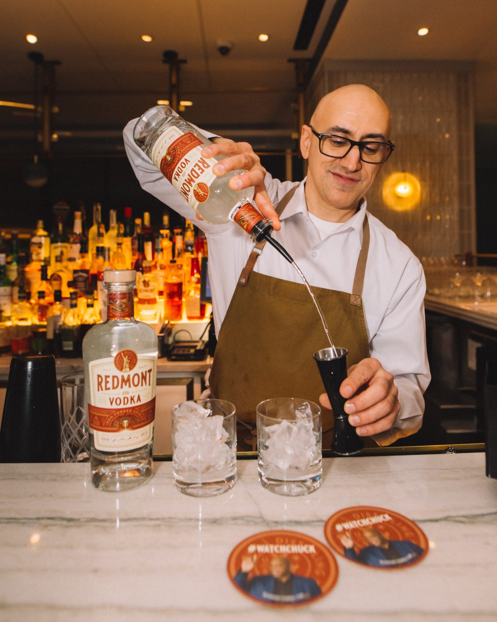 Bartender pouring Redmont Vodka over ice at the Conrad New York launch