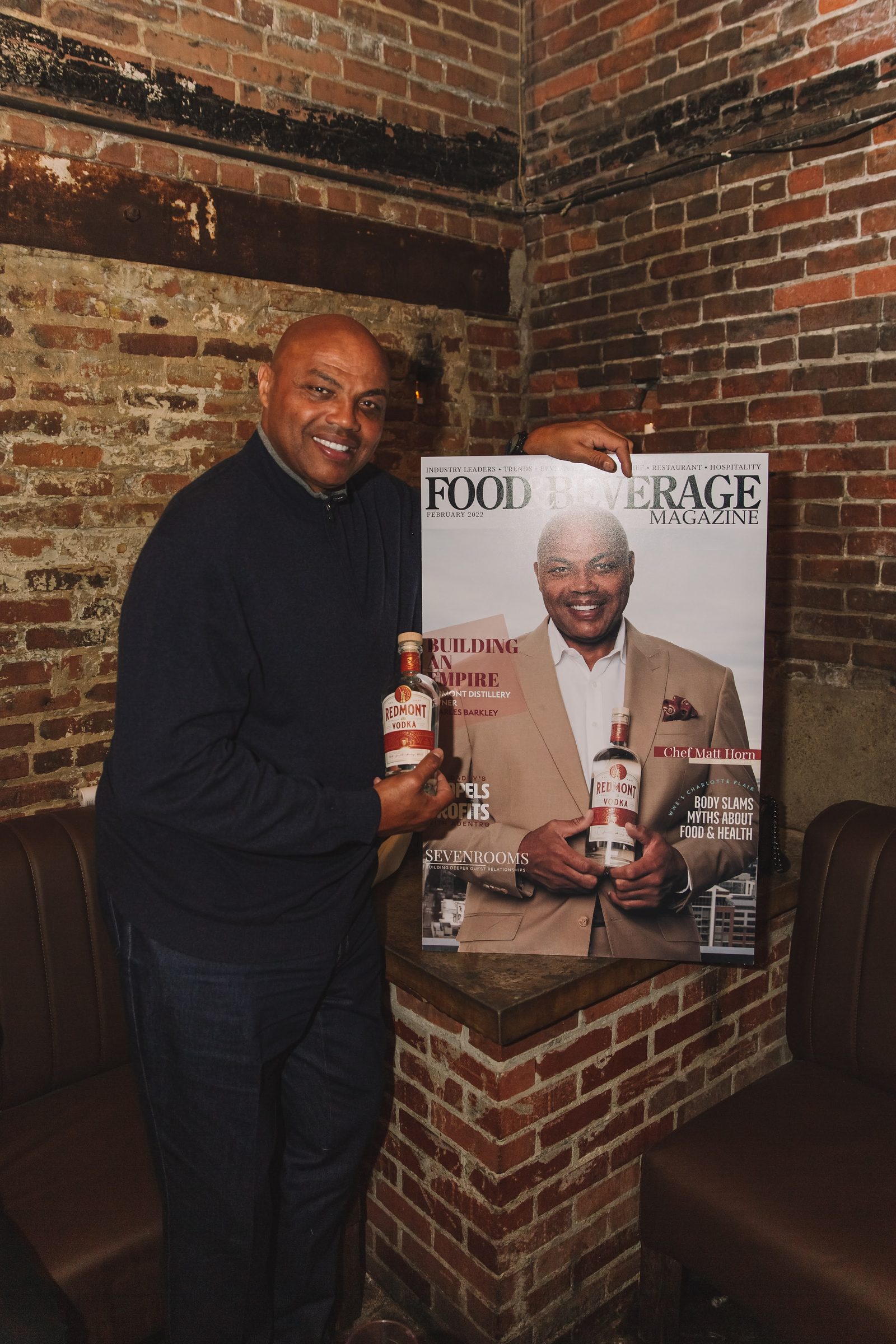 Charles Barkley holding the Food and Beverage Magazine cover at the activation