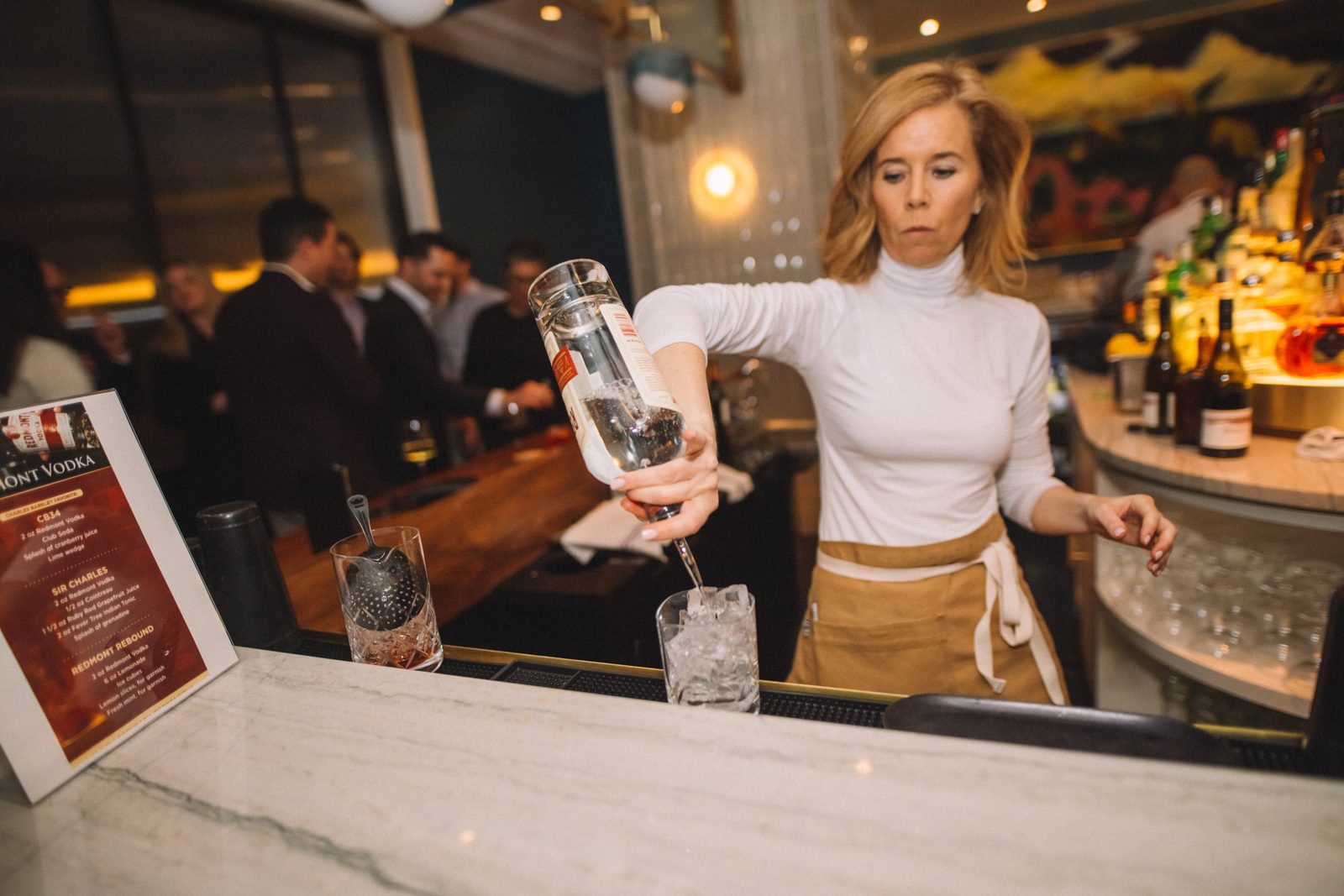Bartender finishing two Redmont Vodka serves on a service tray