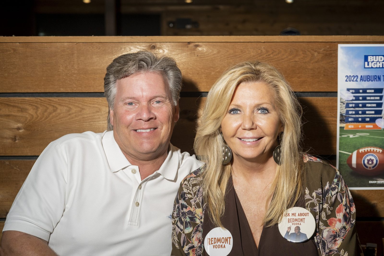 Guests wearing Redmont Vodka buttons at the venue