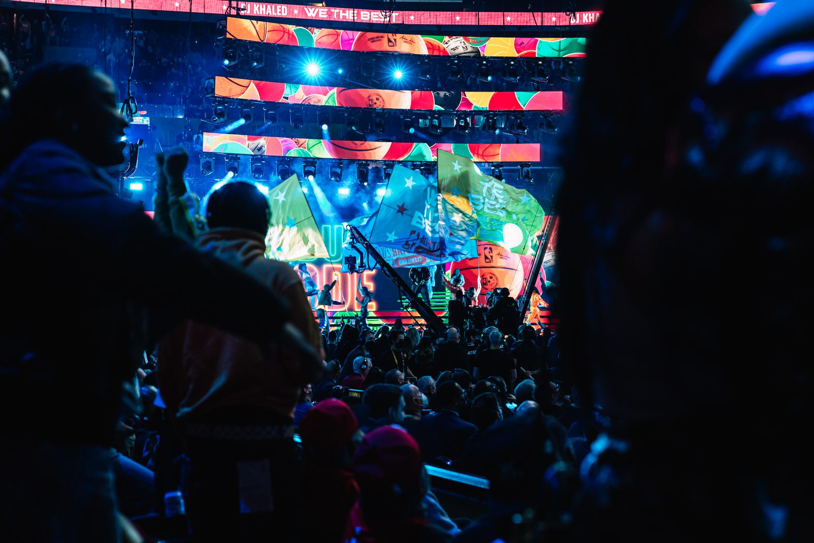 Crowd silhouetted against the arena screens