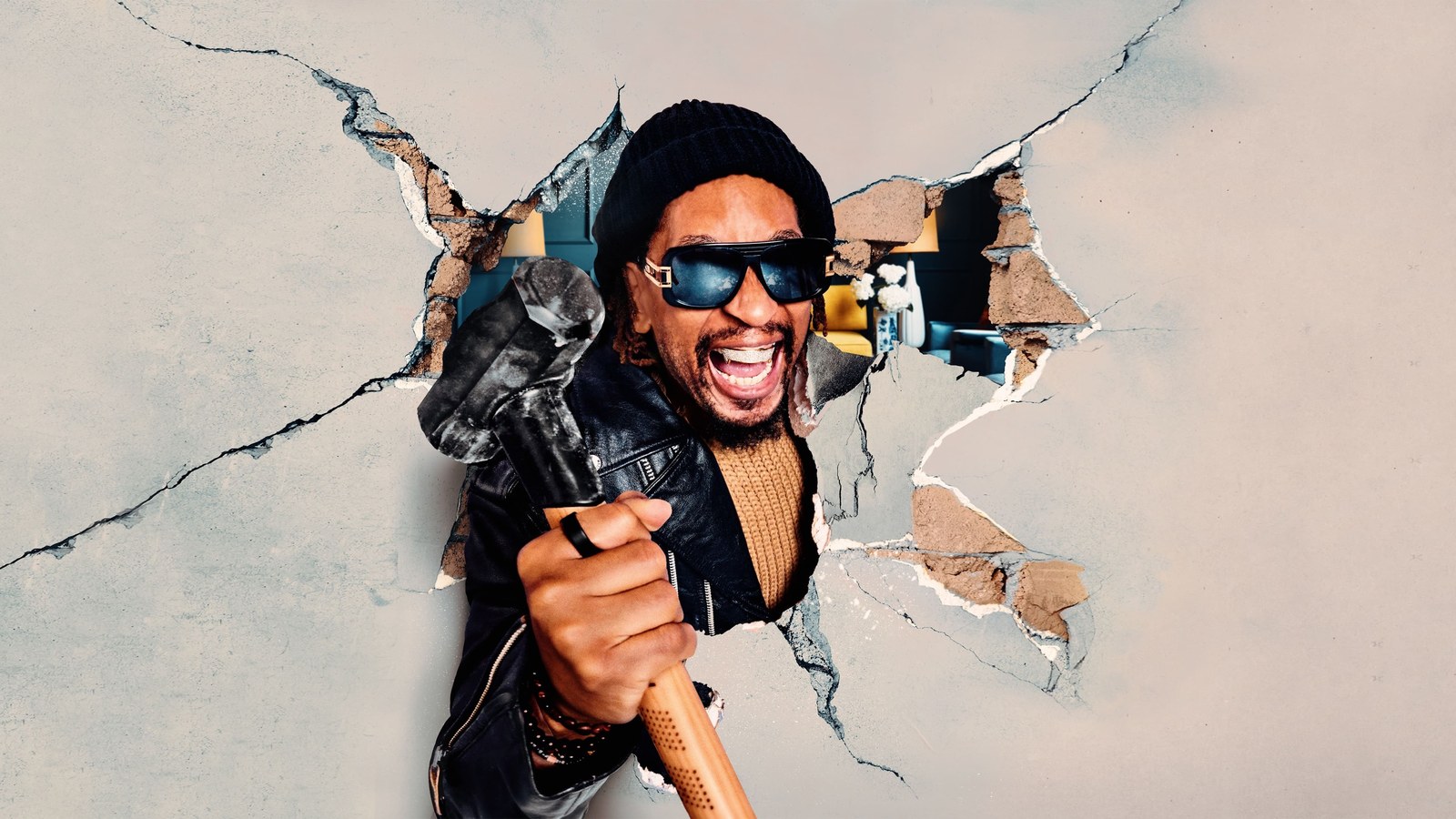 Lil Jon breaking through a plaster wall with a sledgehammer in key art for his HGTV renovation series
