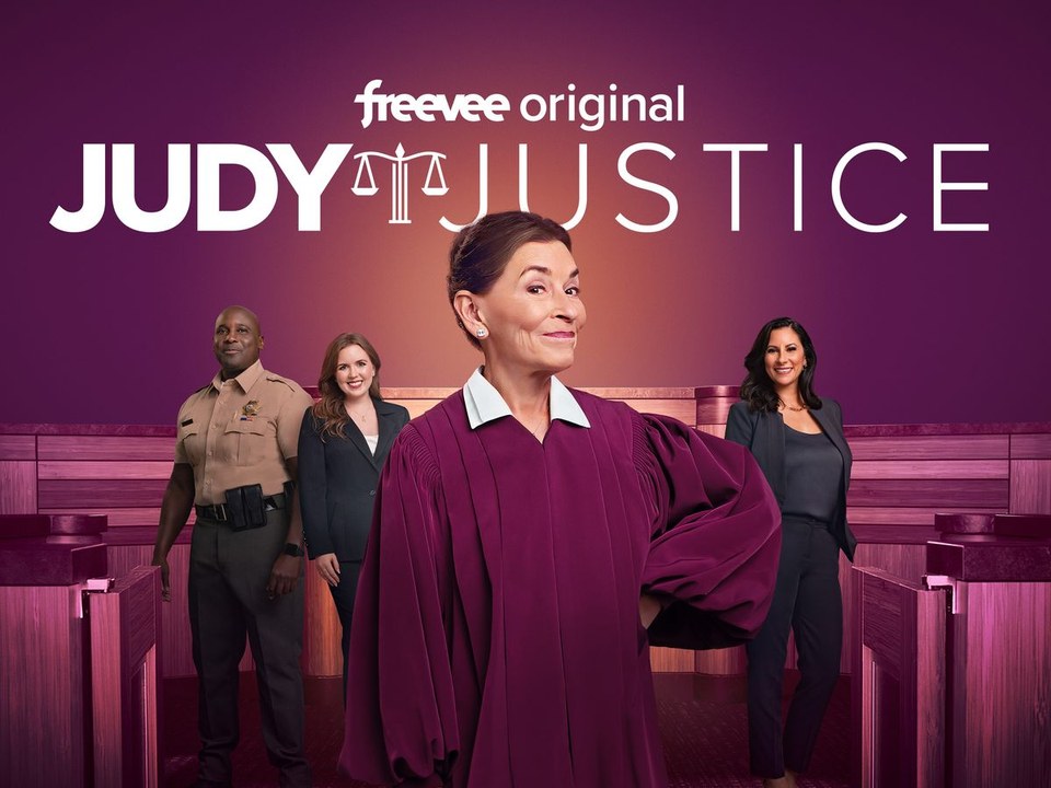 Judy Justice key art, Judge Judy Sheindlin in the magenta courtroom with the show's cast behind her