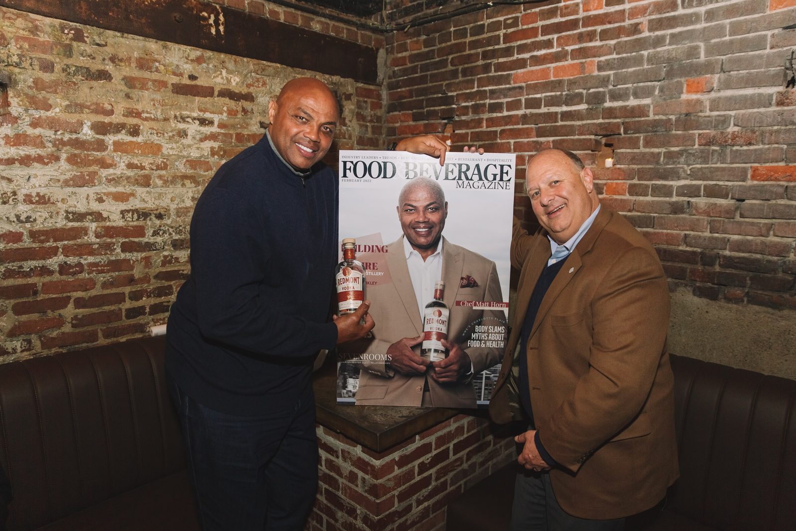 Charles Barkley and guests with the magazine cover at the brick wall