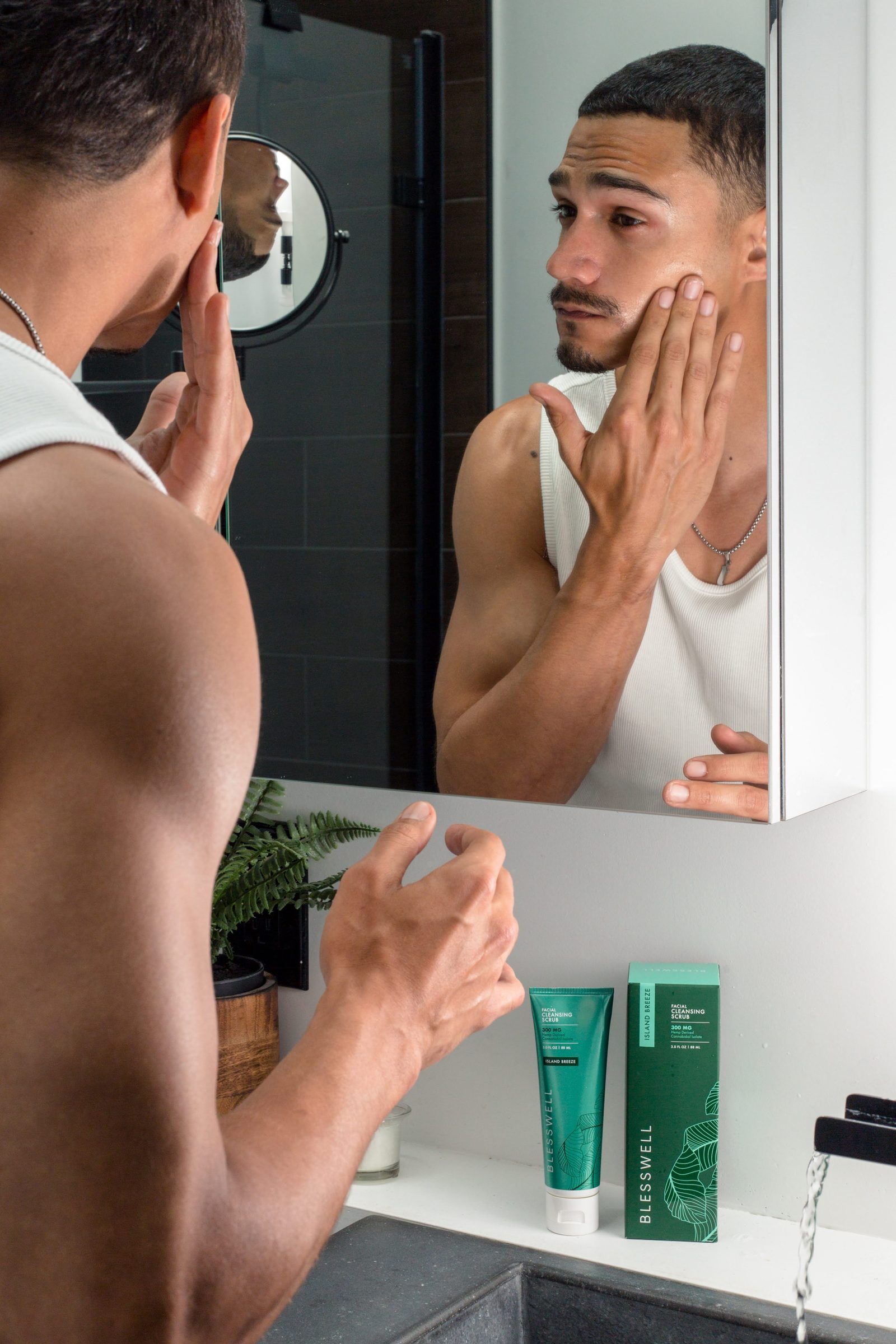 Man applying BLESSWELL grooming cream at the bathroom mirror